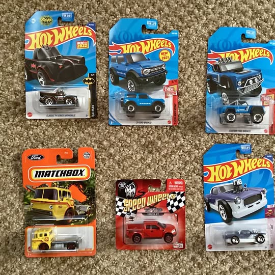 Diecast car blister packs with Hot Wheels and Matchbox branding, multiple vehicles