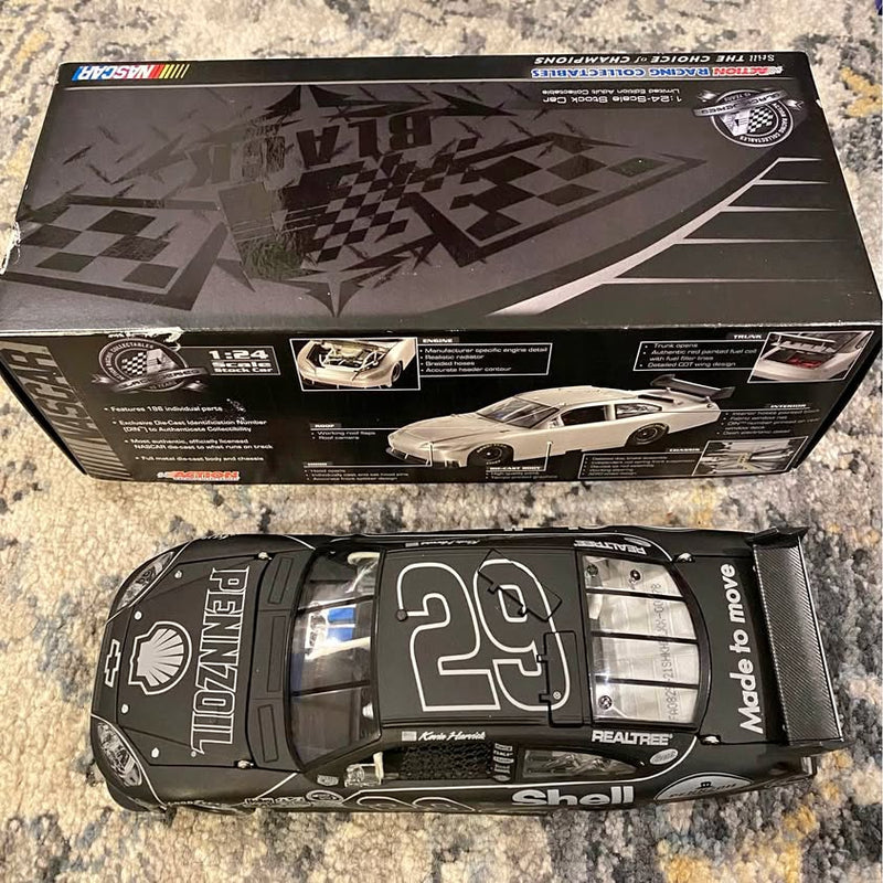 No. 29 diecast race car model with white and gray racing graphics, black base