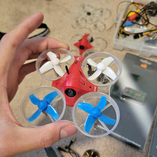 Concord CA drone with red body, four clear propeller guards, and white propellers