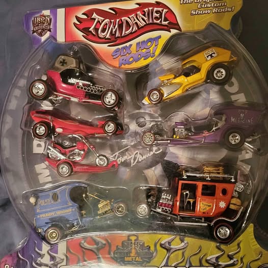 Diecast car collection: blister pack with multiple hot rod cars in red, yellow, purple, and blue