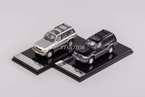 1:64 diecast SUV model cars set, silver and black, on display base