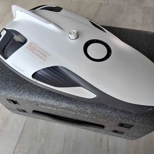 Underwater drone with white body and black trim, oval lens window visible