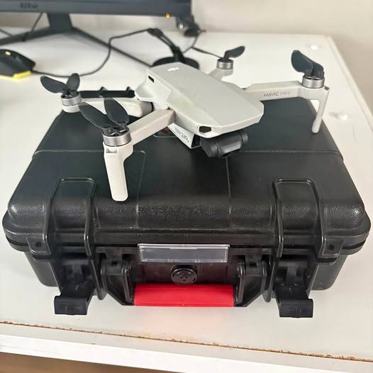 White quadcopter drone in black protective case