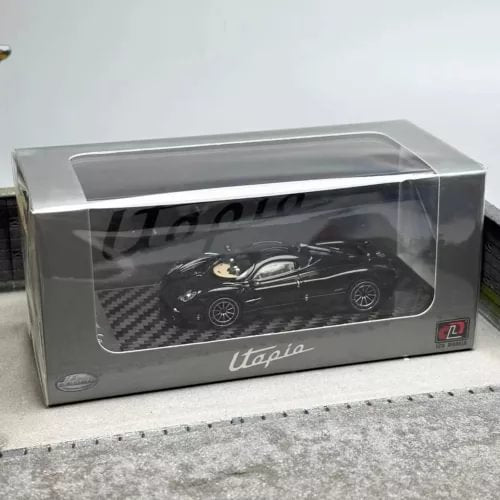 Black diecast sports car model in clear display case, 1:64 scale with printed packaging