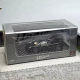 Black diecast sports car model in clear display case, 1:64 scale with printed packaging