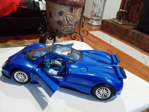 Blue 1:18 scale sports car diecast model with open cockpit and detailed wheels