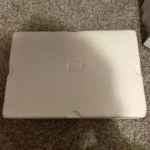 White rectangular drone body/case with small emblem and circular port