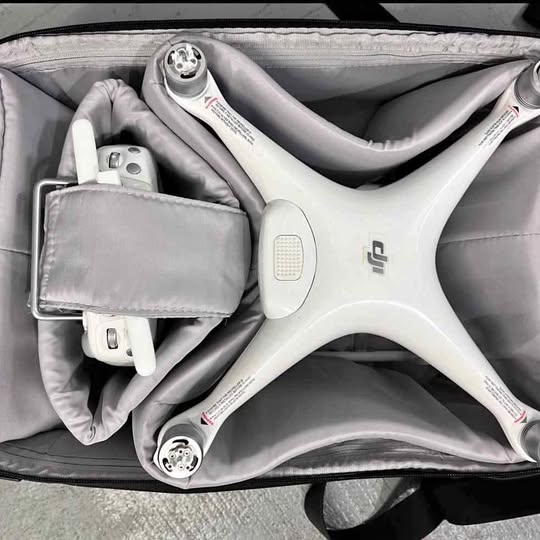 DJI drone with white body and camera, stored in a gray protective case