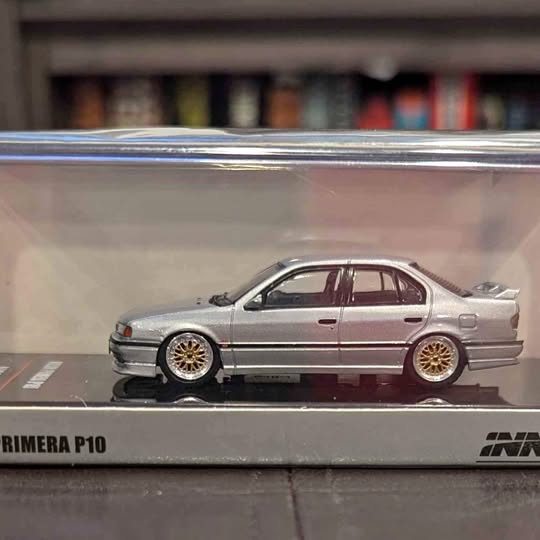 1/64 Nissan Primera P10 diecast car, silver with gold wheels, side view