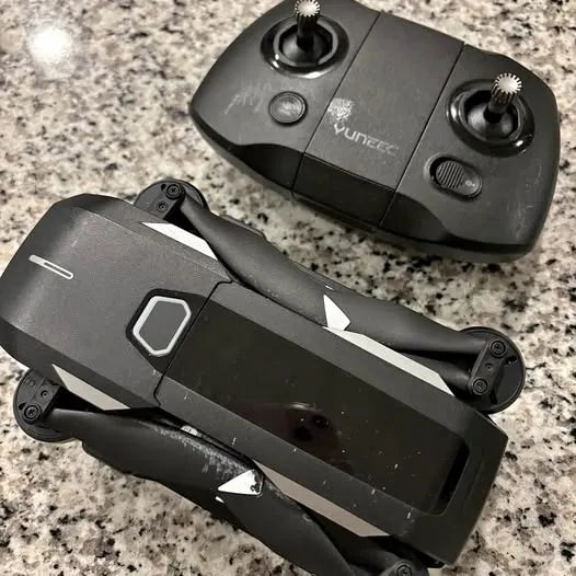 Black quadcopter drone with foldable arms