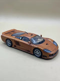 Copper orange diecast sports car model with blue stripes, 1:18 scale, black hood.