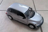 Silver die-cast car model with detailed headlights and wheels