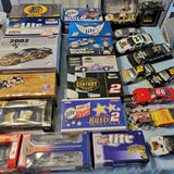 Diecast race car collection set in boxes, with a blue #2 car visible