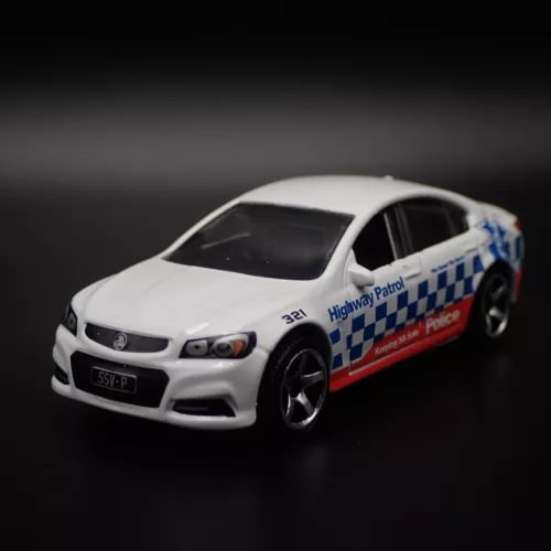 White highway patrol police diecast model car with blue checkered side stripe, front 3/4 view
