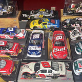 NASCAR diecast race car models in box packaging, various car colors and numbers
