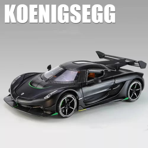 Diecast racing car model, black with green accents, front hood and rear wing