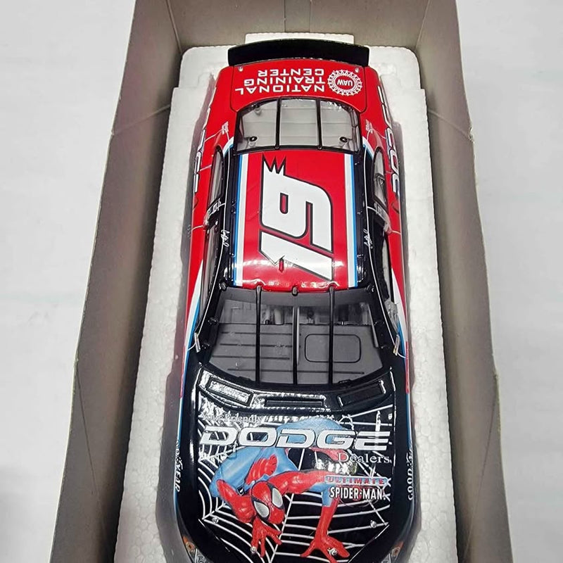 Diecast race car with red, white, and black Spider-Man hood graphics in packaging