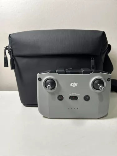 DJI RC231 remote controller with gray body and black carry case, front view