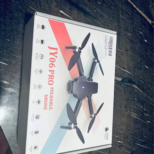 Jy06 Pro foldable drone retail box, shown with camera module and four propellers