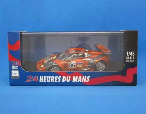 1:43 diecast car model in box, orange race car with number 86, 24 Heures du Mans text