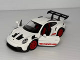 White Porsche 911 GT3 RS diecast model car toy with red wheels and rear spoiler