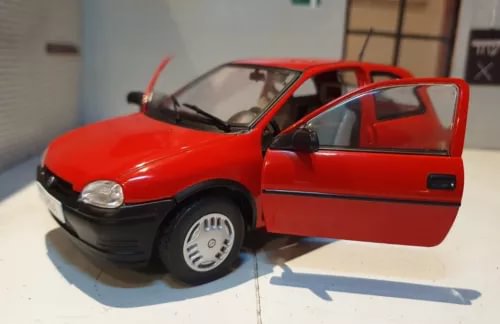 Red 1993 three-door diecast model car, front-left view, 1:24 scale, detailed wheels