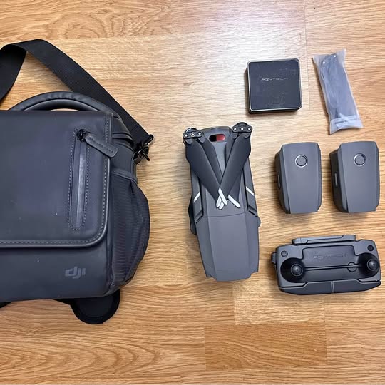DJI drone accessory kit with carry bag, batteries, and remote controller