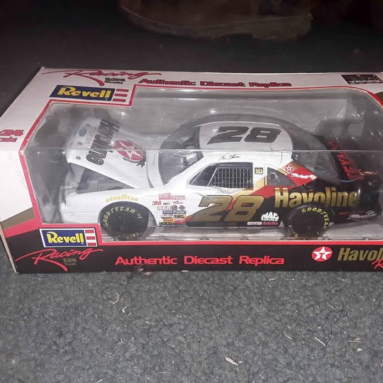 1:24 scale diecast race car replica in clear retail display case