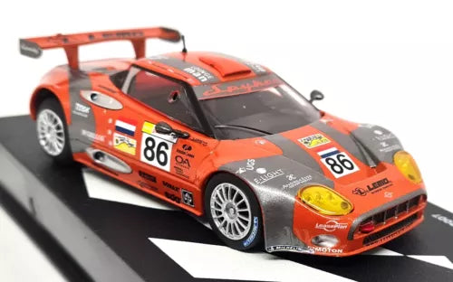 Orange and black race car diecast model with #86 decals and front grille detail