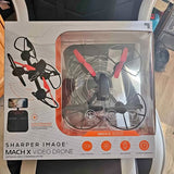 Video drone in retail packaging, featuring a quadcopter with orange prop guards