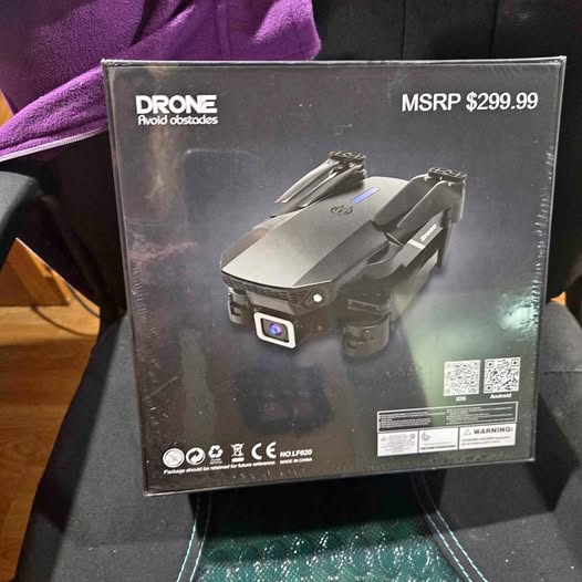 Drone retail box with front view illustration and warning labels