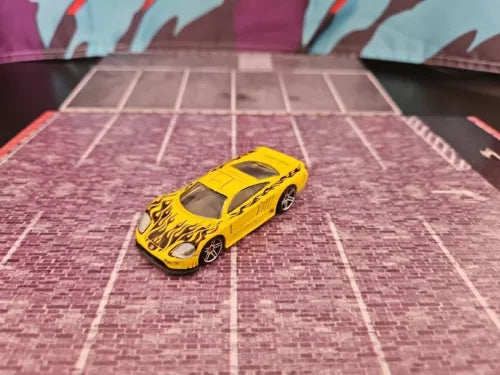 Hot Wheels Saleen S7 diecast model car, yellow, 1:64 scale