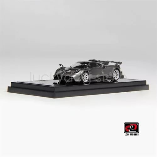 1:64 scale metallic grey diecast model car on black display base