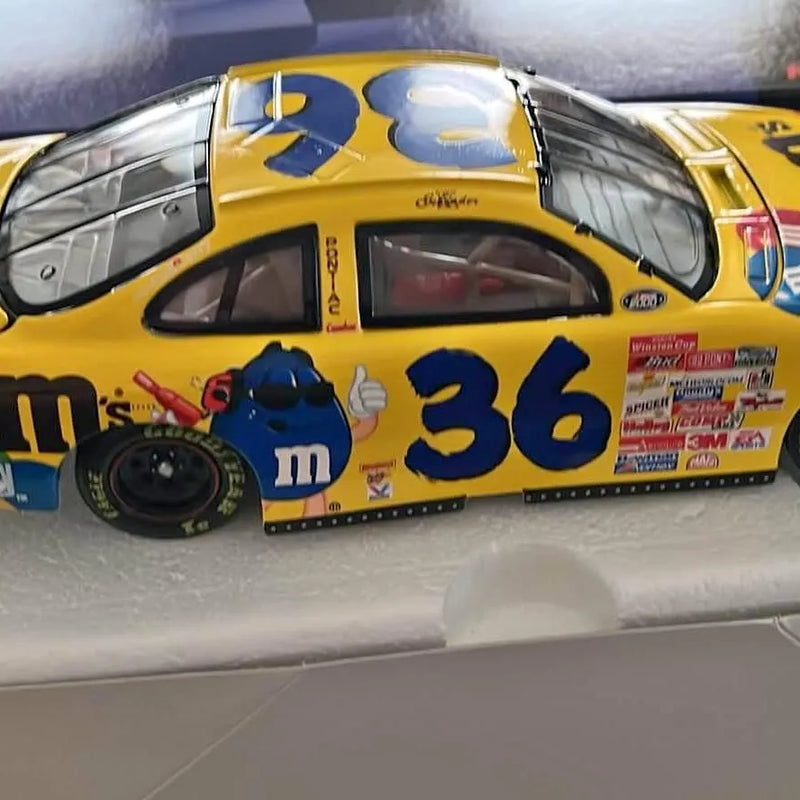 Yellow and blue #36 diecast race car with open cockpit and M&M logo
