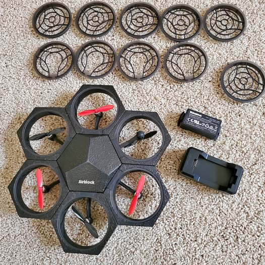 Modular programmable drone body with five propeller guards and pink propellers