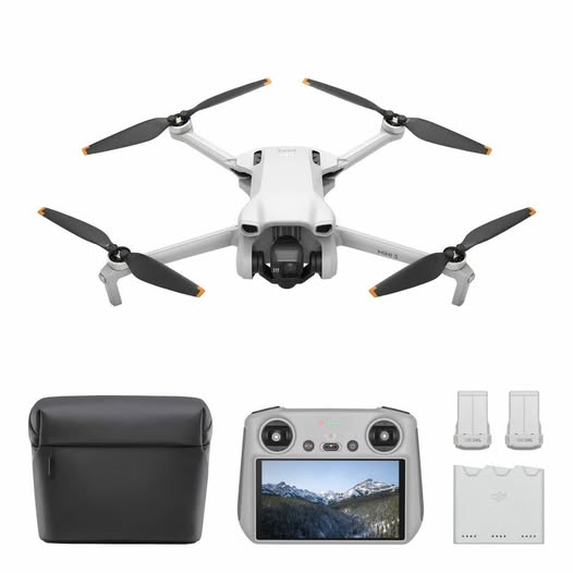 White quadcopter drone kit with gray controller, carrying case, 2 batteries, prop guards