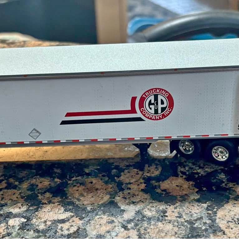 Diecast tractor trailer replica trailer side with G&P Trucking logo and red stripes
