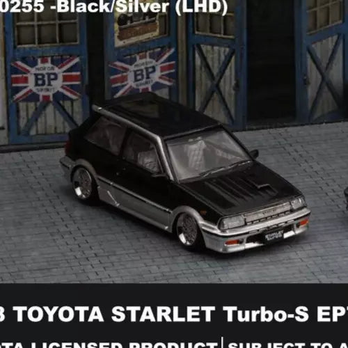 Black and silver diecast sports car model, front 3/4 view with silver bumper