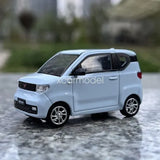 Light blue 1/64 scale diecast car model, compact hatchback, front three-quarter view