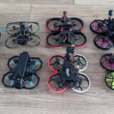 FPV drone quadcopter with black frame, four propellers, and red accents