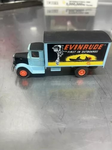 Light blue diecast Mack truck with Evinrude logo trailer, red wheels