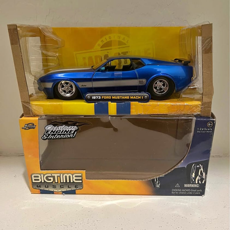 Blue and silver diecast 1973 Ford Mustang Mach 1 toy car in box with clear cover