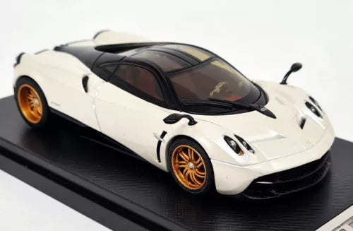 Pearl white supercar diecast model car with black hood vents and gold wheels