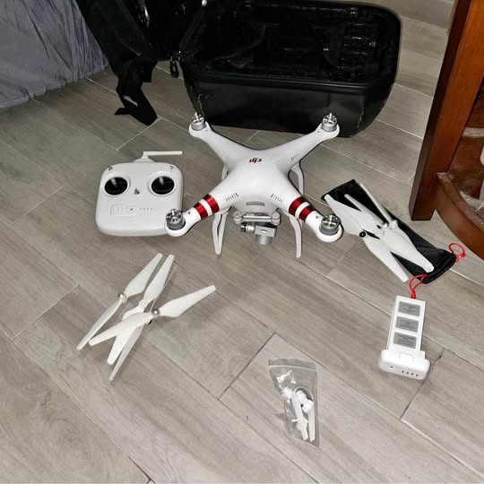 DJI Phantom 3 drone with white body, controller, spare propellers, and prop guards