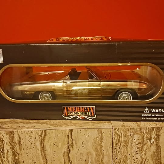 1:18 diecast car model in gold-tone finish, front view in clear display box