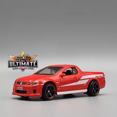 Red Holden SSV diecast pickup truck model with black wheels and grille detail