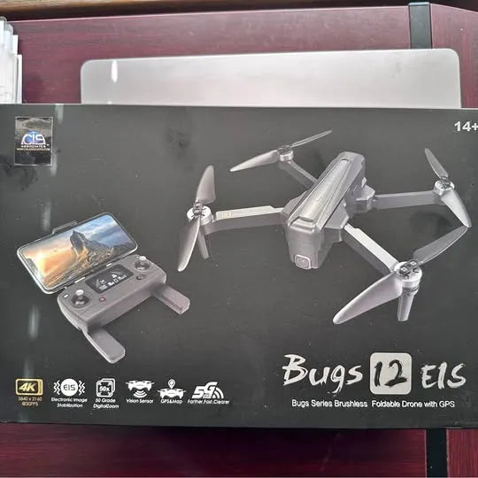 Foldable GPS drone with controller and four propellers, smartphone screen visible