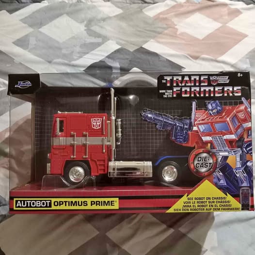 Boxed 1:24 diecast Optimus Prime truck with red and blue detailing