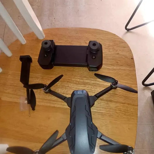Compact foldable drone with four propellers and dark gray body