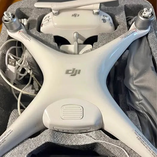 DJI Phantom 4 drone, white body with four arms and visible propellers